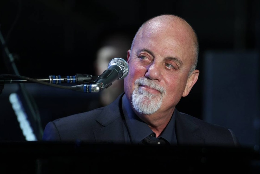 Close up of Billy Joel performing at a piano