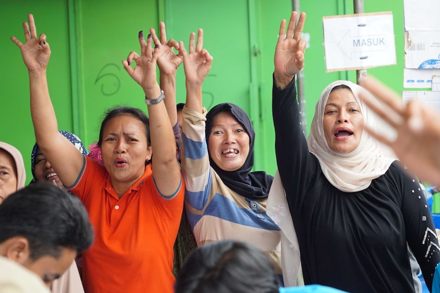 Three women voters celebrating Anies Baswedan's win.