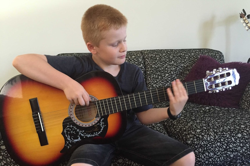 Bailey plays a guitar.