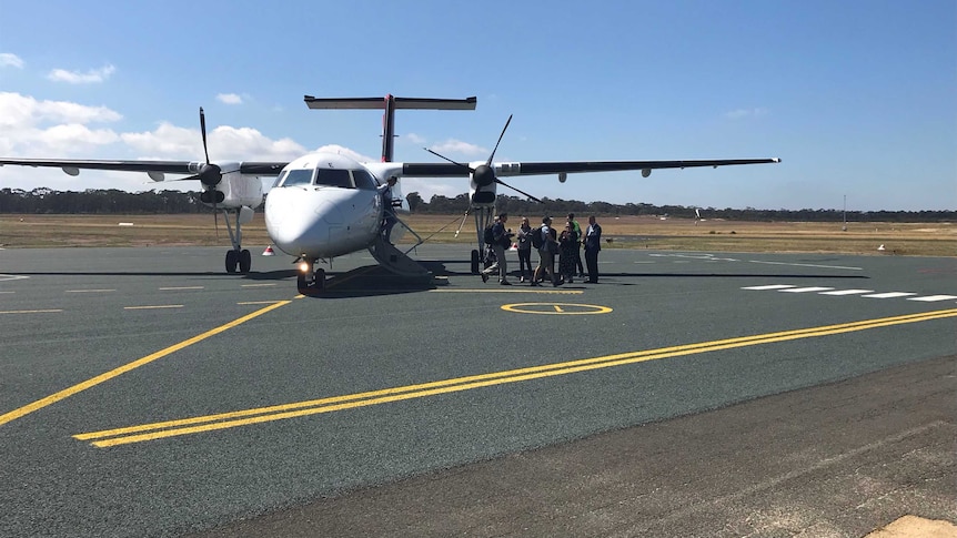 Passengers disembark from a Qantas Link plane