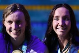 Katie Grimes, Katie Ledecky and Lani Pallister hold their medals and smile for the camera at the world swimming championships.