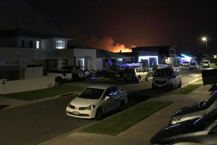 Street at night with fire in background