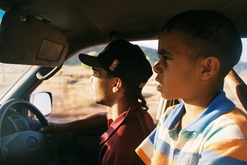 Two young Carter family boys sit in a car
