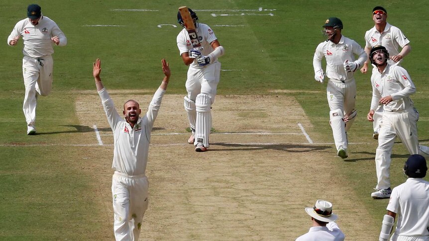 Australia's Nathan Lyon celebrates the wicket of India's Ishant Sharma with his teammates.