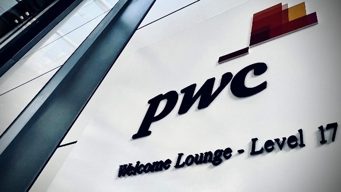 A PwC logo on the side of a building.