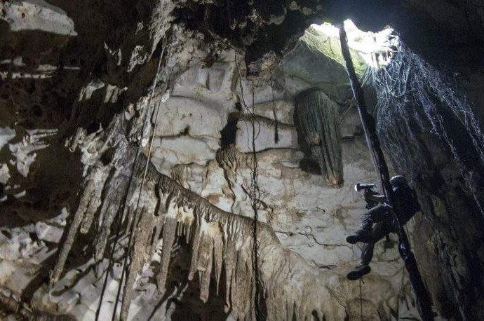 Engineer Corey Jaskolski scans the entrance to Cenote Holtun in Chichen Itza, Mexico.