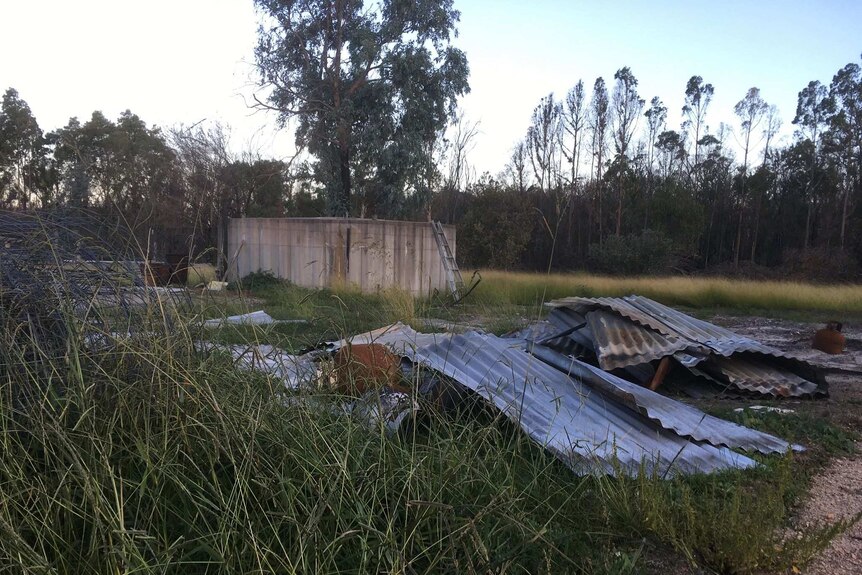 bushfire damaged concrete tank and corrugated iron