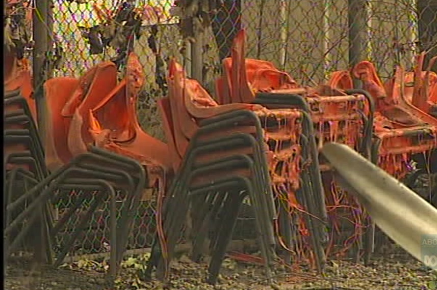 School chairs with melted orange plastic.