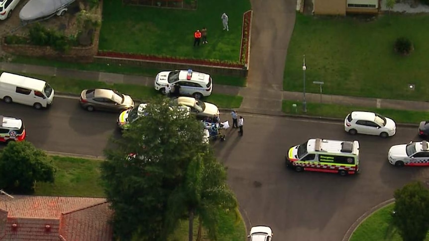 An aerial shot of police cars and ambulances