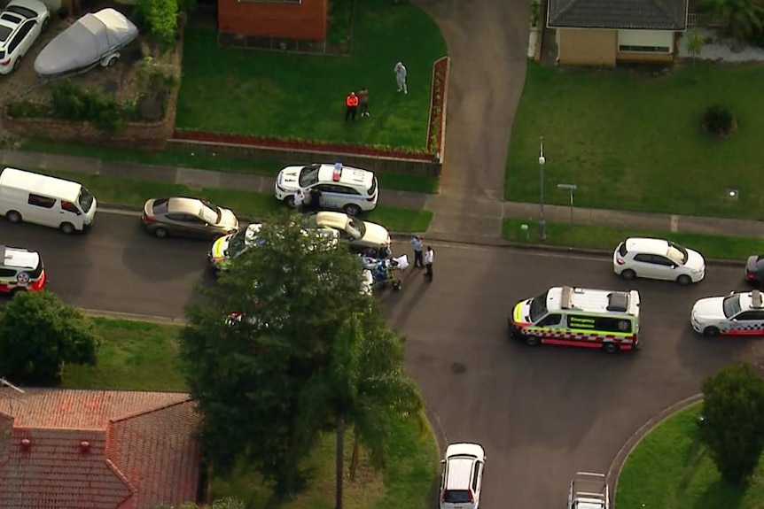 An aerial shot of police cars and ambulances