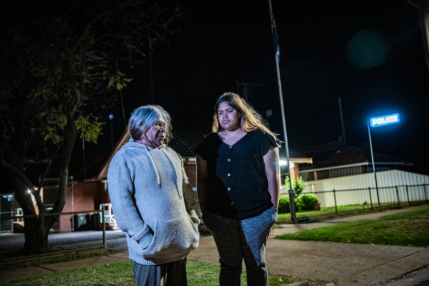 An older aboriginal woman standing with a younger woman