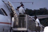 Sri Lankan asylum seekers board a plane on Christmas Island bound for Nauru.
