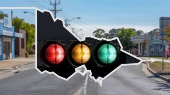 An image of red, amber and green traffic lights on a map of Victoria, against a backdrop of regional Victoria.