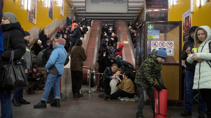 People gather in a subway station being used as a bomb shelter in Kyiv.