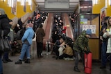 People gather in a subway station being used as a bomb shelter in Kyiv.