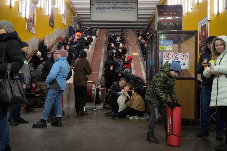 People gather in a subway station being used as a bomb shelter in Kyiv.
