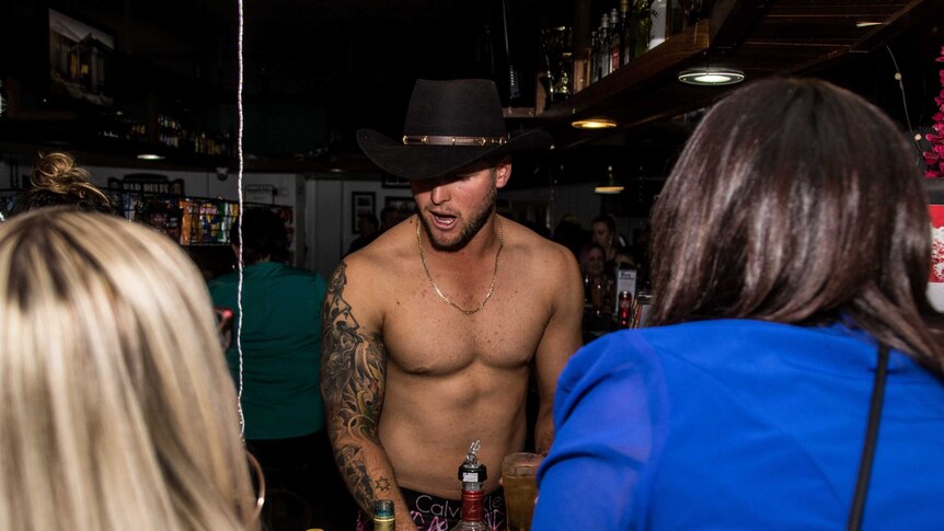 Shirtless male bartender