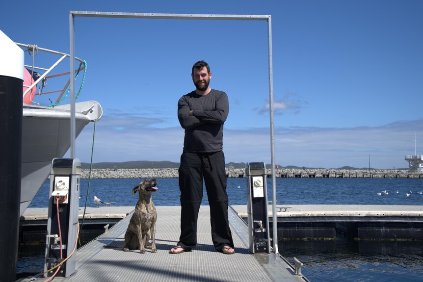 man and dog on jetty 
