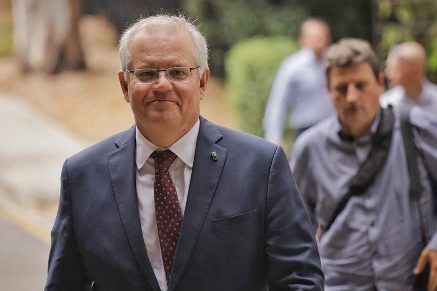 Prime Minister Scott Morrison smiles as he arrives at the University of Queensland in Brisbane.