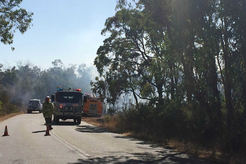 A road in Darlington is blocked as firefighters tackle bushfire