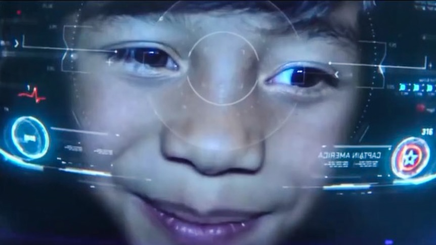 A young boy looking out of a virtual reality headset.