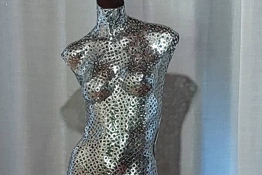 An image of a mannequin statue made out of steel washers