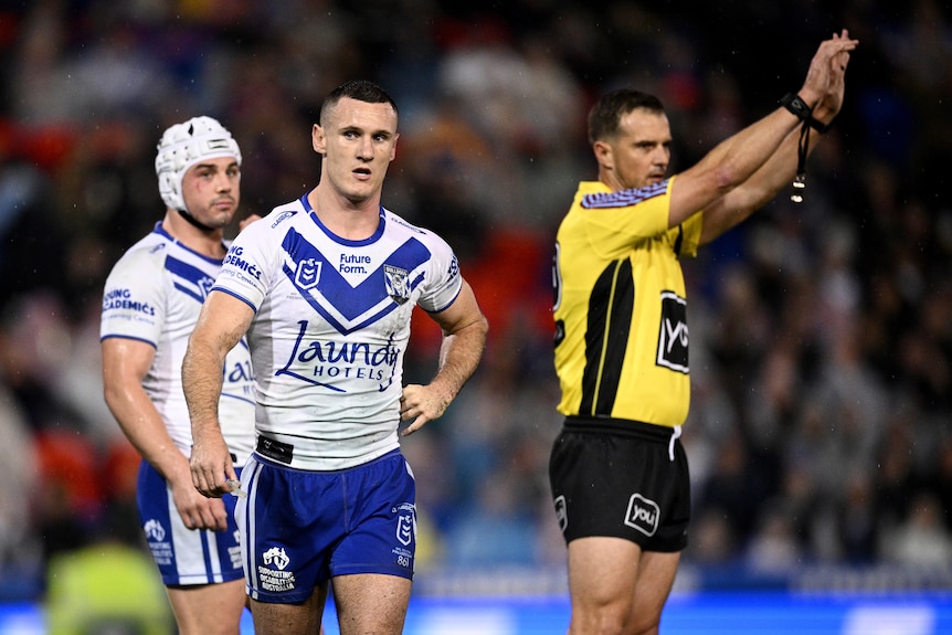 NRL player Connor Tracey looks frustrated as the referee holds his hands in the air, sending Tracey to the sin-bin