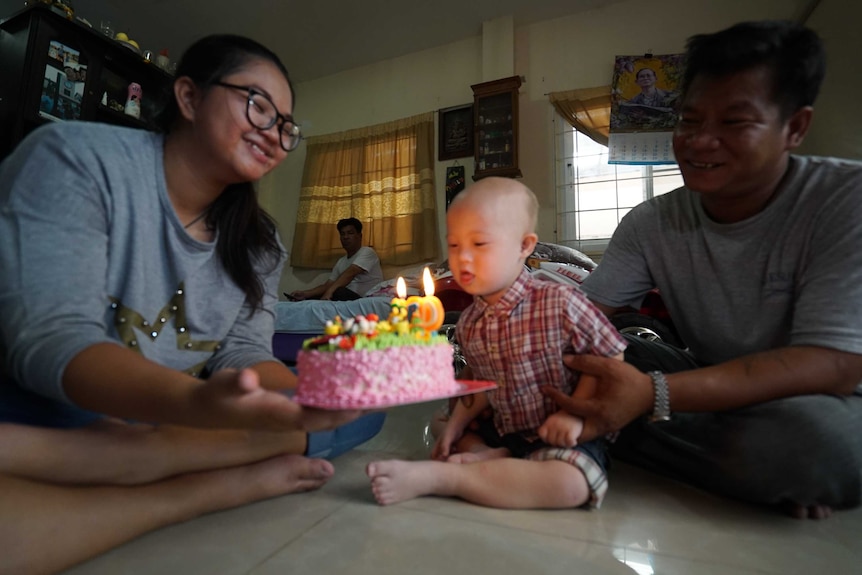 Grammy celebrates his birthday with his family, and gets ready to blow out the candles on his pink coloured cake.