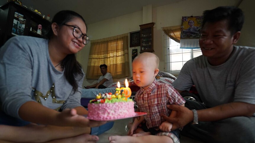 Grammy celebrates his birthday with his family, and gets ready to blow out the candles on his pink coloured cake.