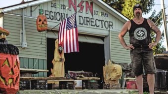 Daniel Burnside, a self-described "proud racist"' stands in front of his home.