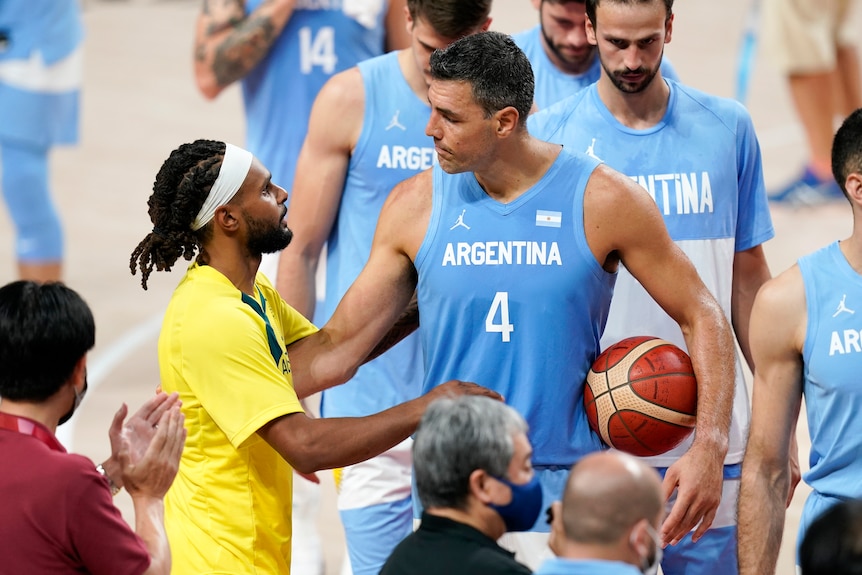 Australia's Patty Mills speaks to Argentina's Luis Scola after their basketball quarter-final.