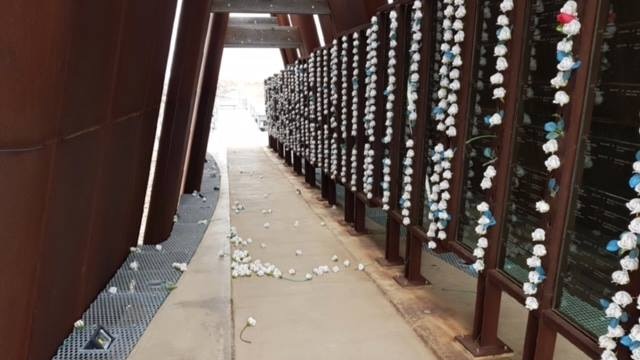 Flowers litter the floor at the Broken Hill Miners Memorial after a vandalism attack.