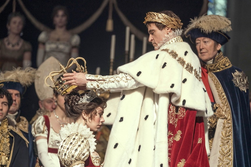 Joaquin Phoenix as Napoleon crowns Vanessa Kirby as Josephine the empress of France in a biopic of Napoleon Bonaparte.