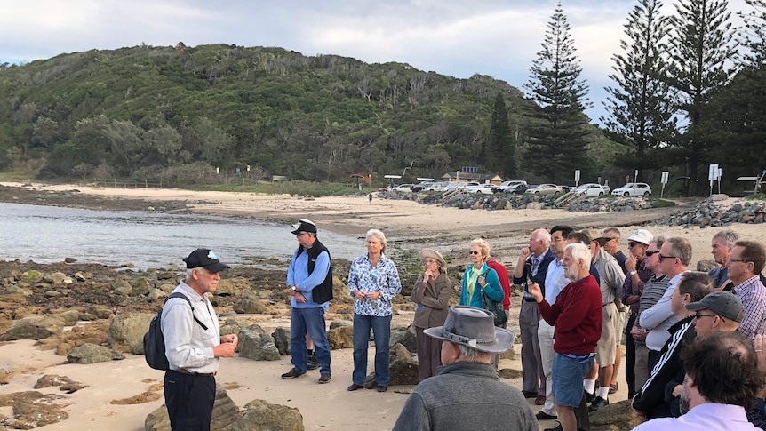 People on Port Macquarie's Shelly Beach listening to Professor Ron Boyd explain why the rocks are special.