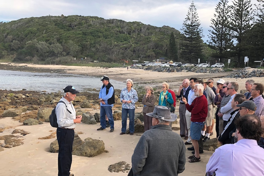 People on Port Macquarie's Shelly Beach listening to Professor Ron Boyd explain why the rocks are special.