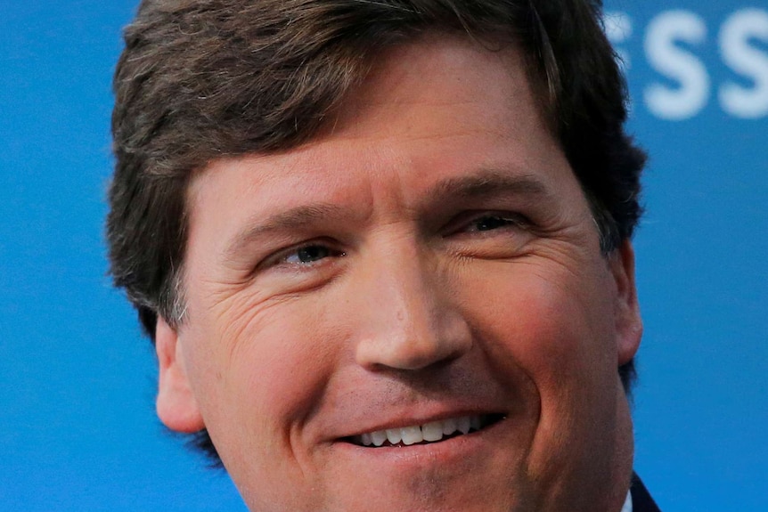 Tucker Carlson Fox News host, facial close up with a happy expression.