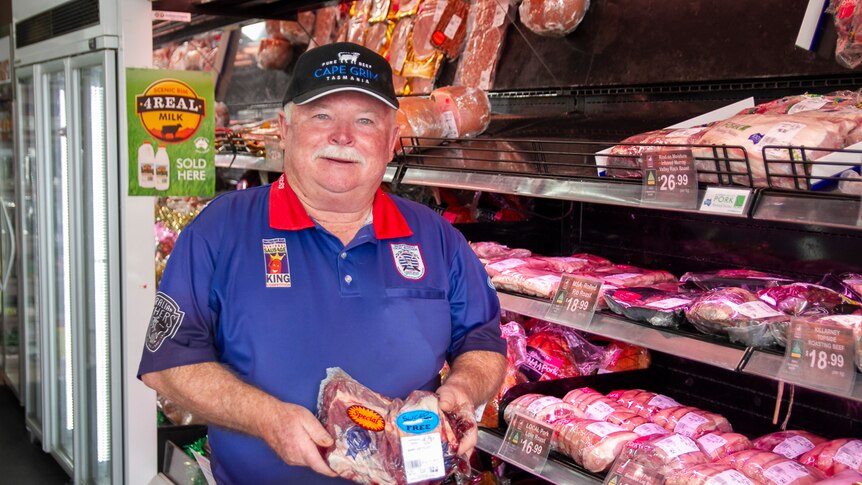Toowoomba butcher John Yeo holding a slab of meat in his shop.