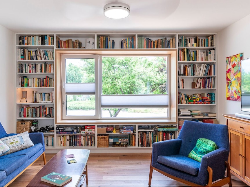 An image of a library with a big window in the middle creating lots of natural light