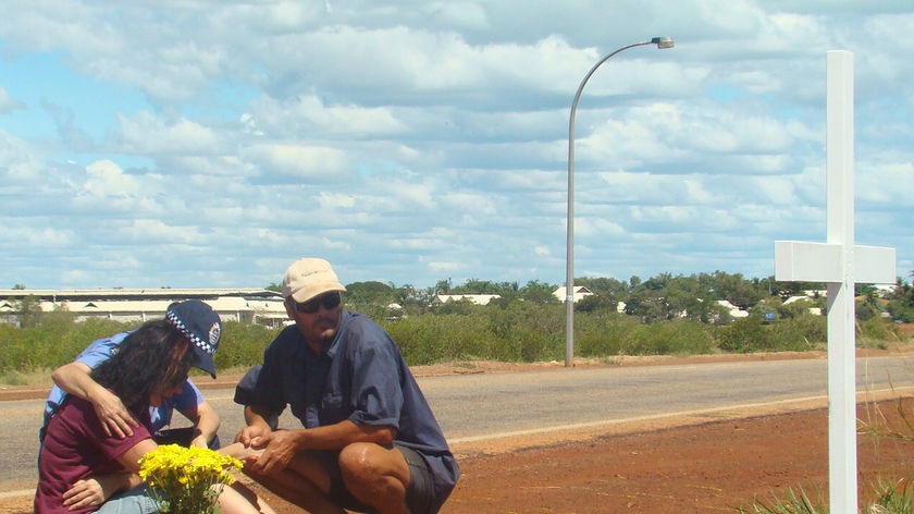 Ingrid Bishop is consoled after erecting a cross at site of son, Josh Warneke's death, Broome