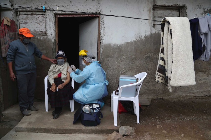 A woman gets a flu shot in a poor neighbourhood in Lima, Peru.