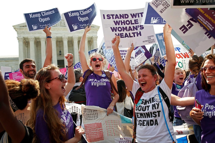 Demonstrators celebrate out the front of the US Supreme Court.