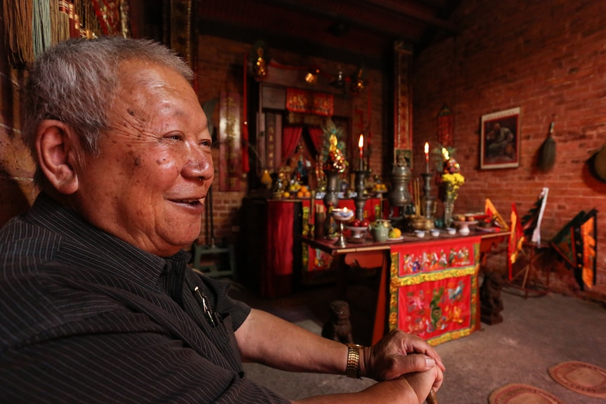 Former academic and volunteer at the Bendigo Joss House, Dennis O'Hoy at the main altar.