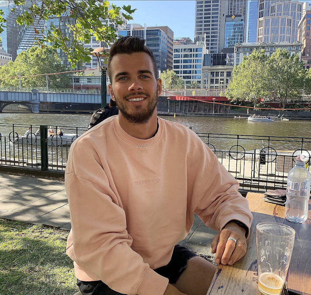 jesse baird smiles as he looks at the camera