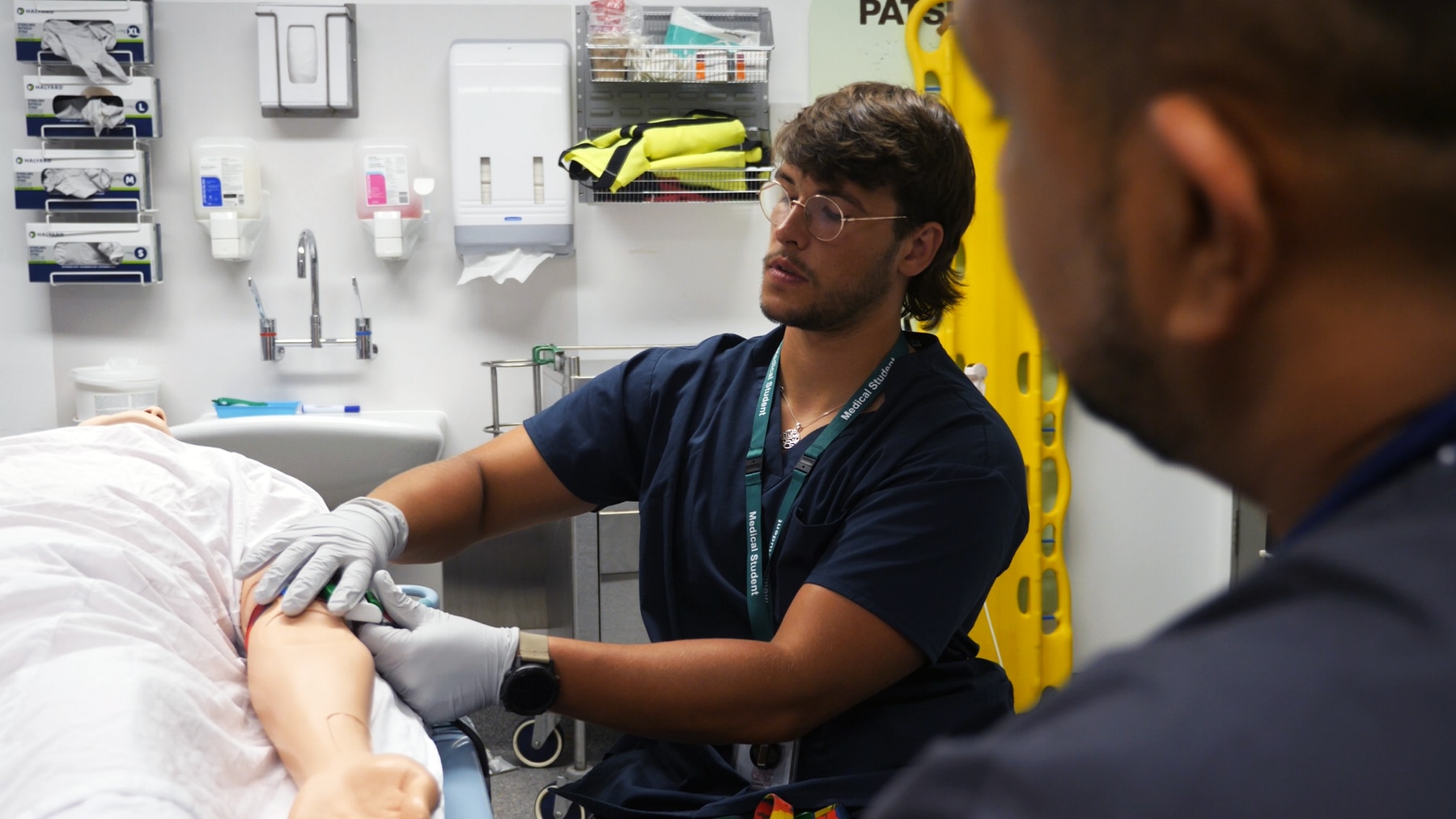 man in wheelchair looking at a hospital bed