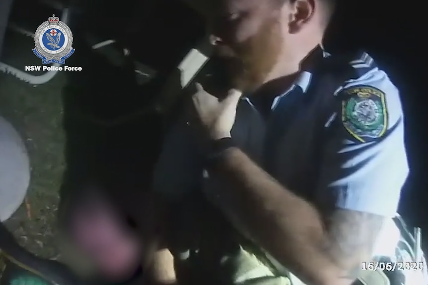 Close up of an officer speaking into his radio calling for back up