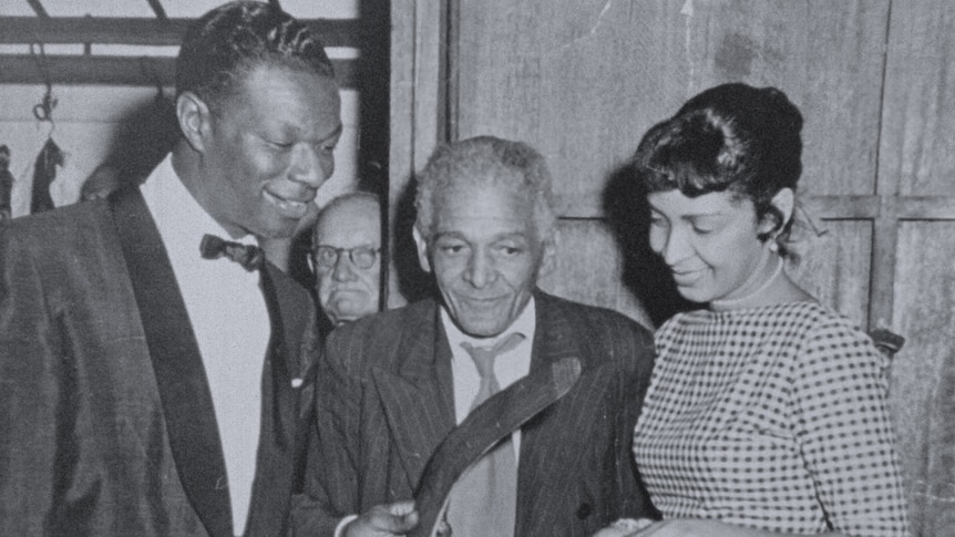 Nat King Cole meets with members of the Coolbaroo Club in 1956, who present him with a boomerang