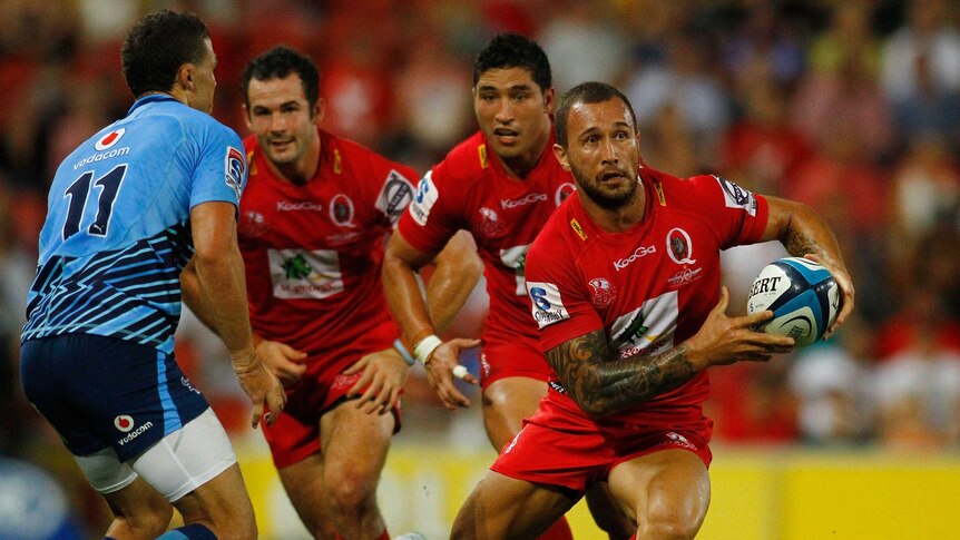 On the attack ... Quade Cooper looks to beat the Bulls' defence