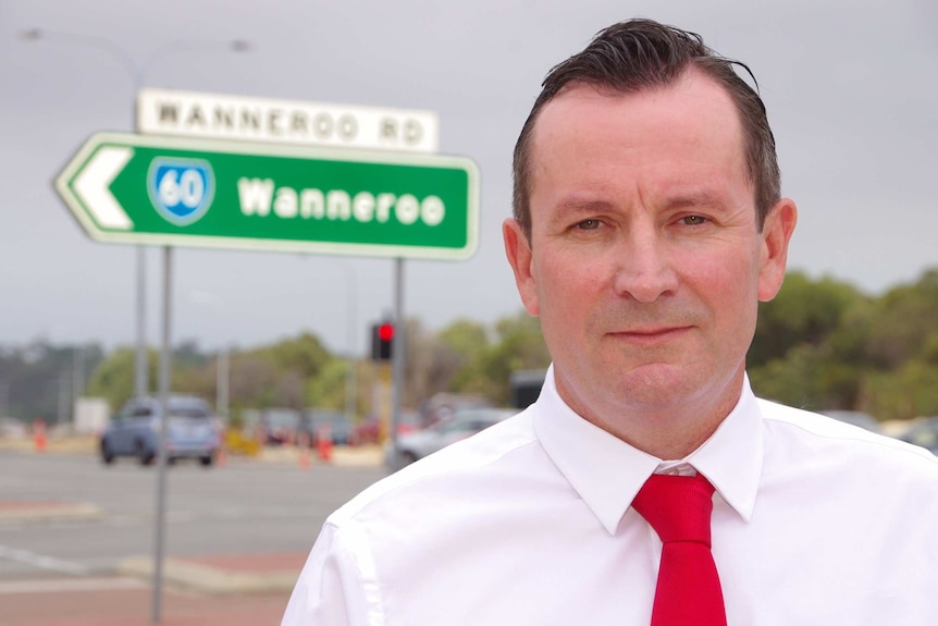 Mark McGowan in front of a road sign for Wanneroo announcing a funding pledge.
