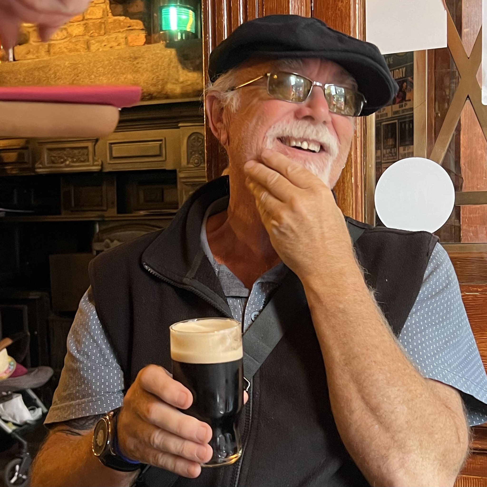 Paul Beard holds a drink in one hand.