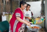 Grandma Erneti with Lara Lee cooking rendang in an Indonesian kitchen.